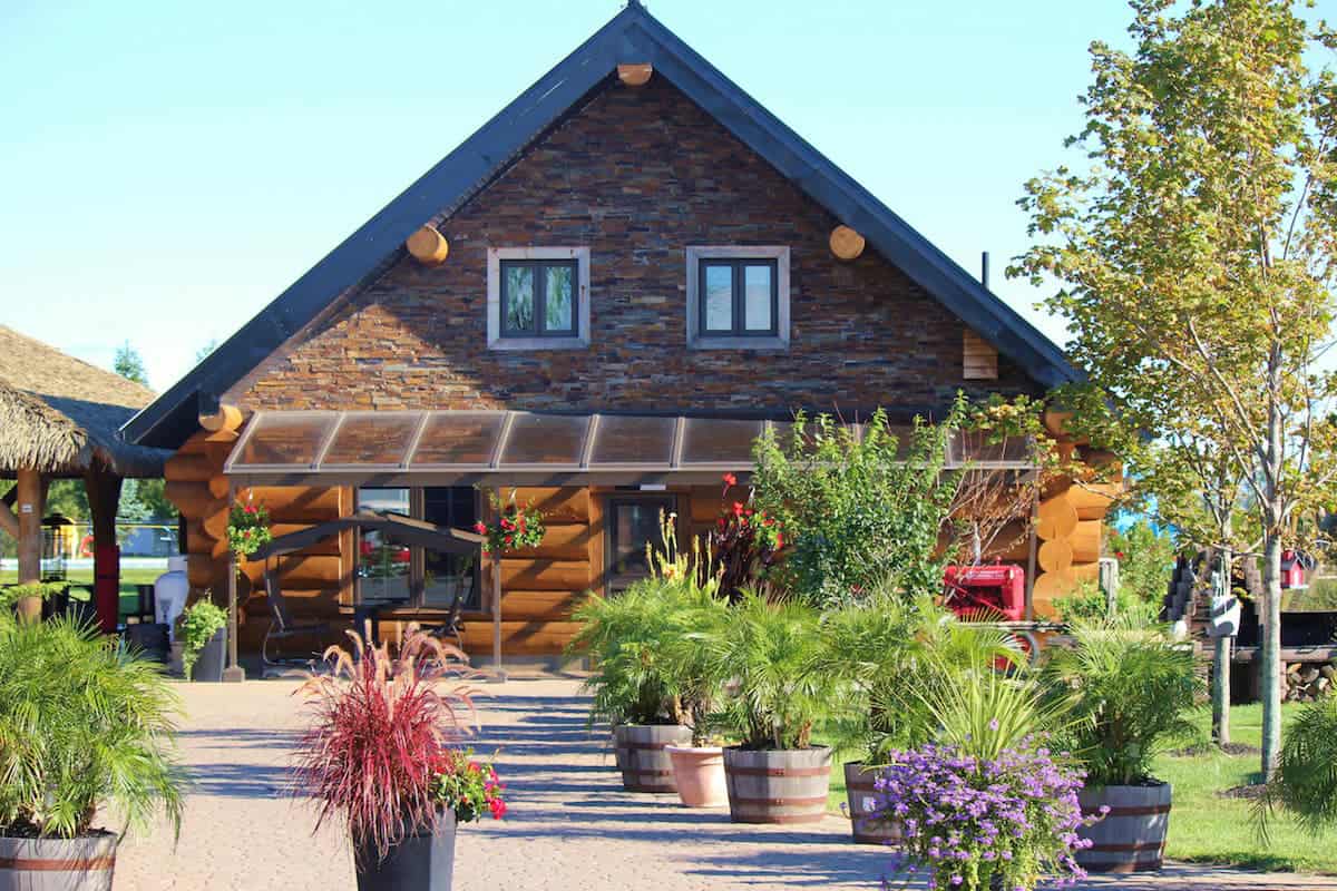 Chalet rustique entouré de végétation luxuriante.